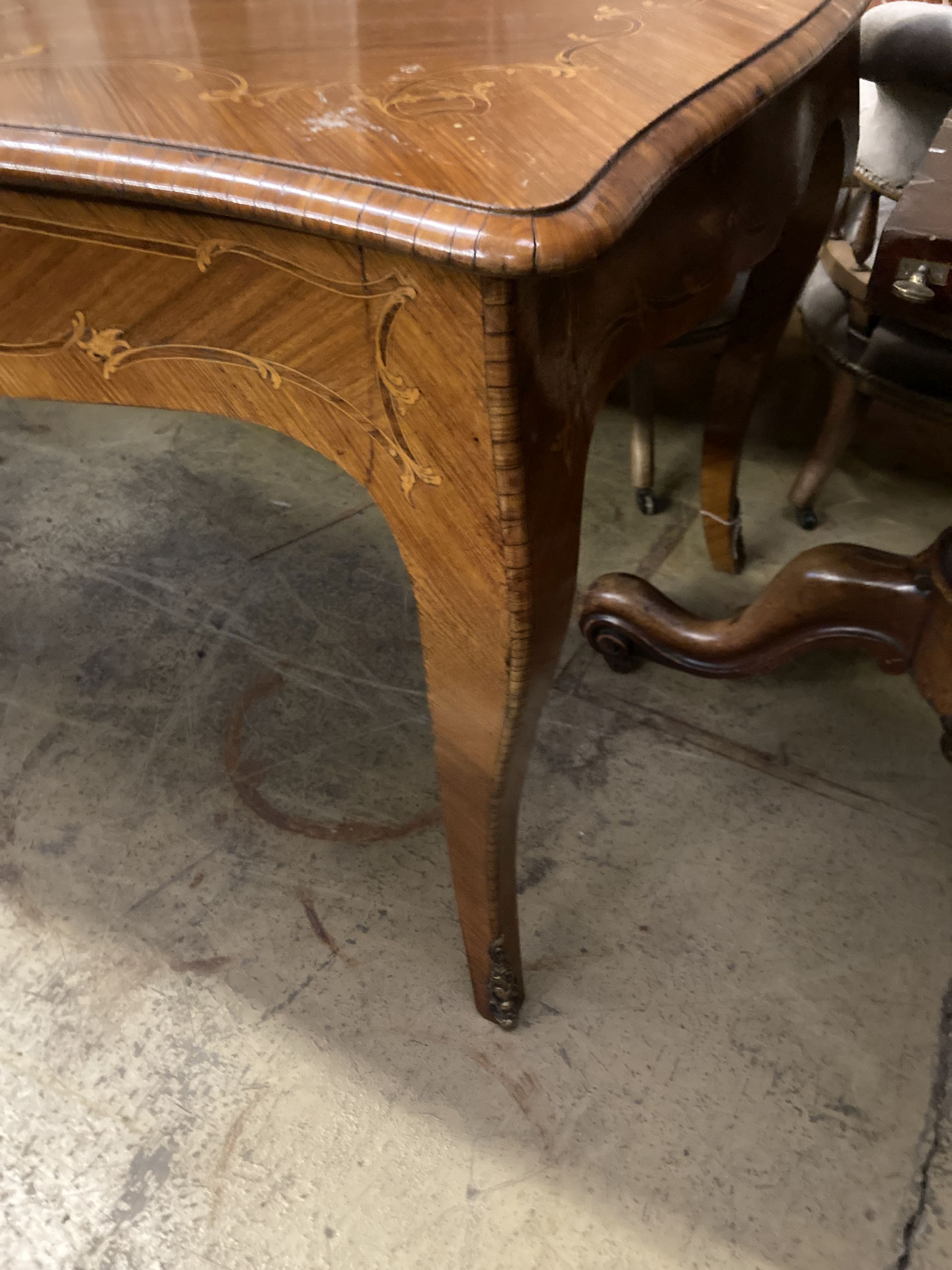 A Louis XVI design marquetry inlaid kingwood serpentine centre table W.196cm. D.90cm. H 79cm.